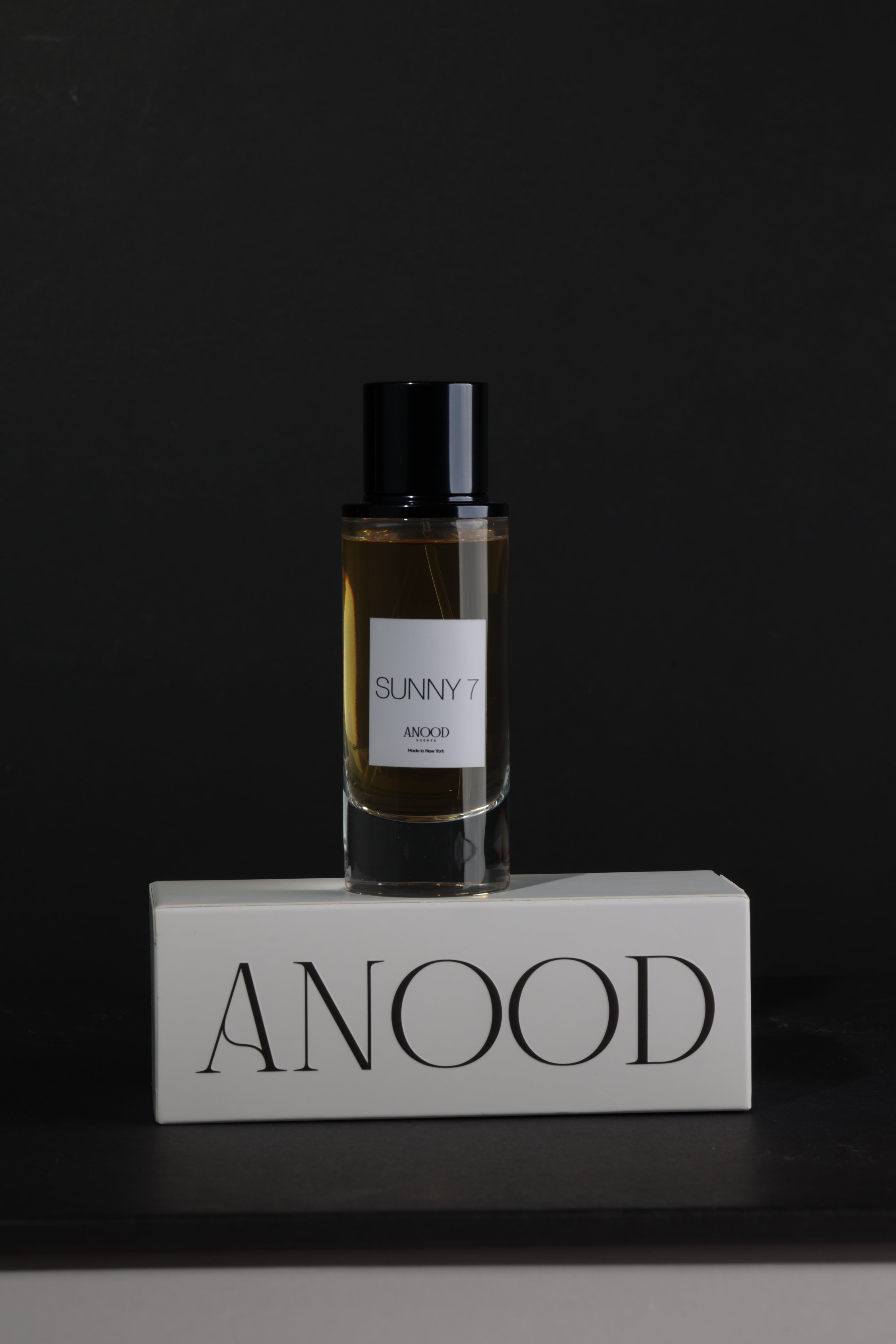 Perfume bottle with a label on a dark background