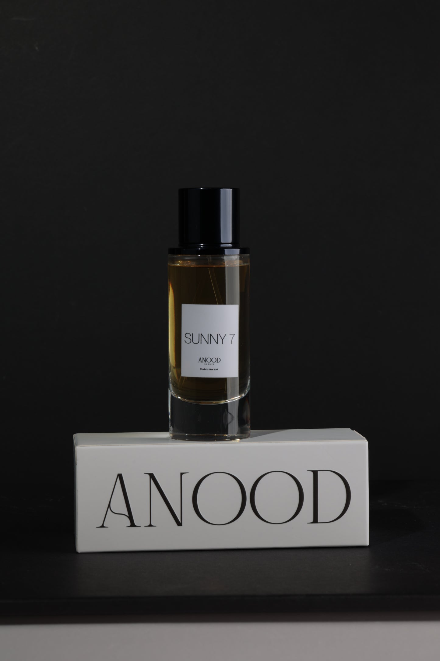 Perfume bottle with a label on a dark background