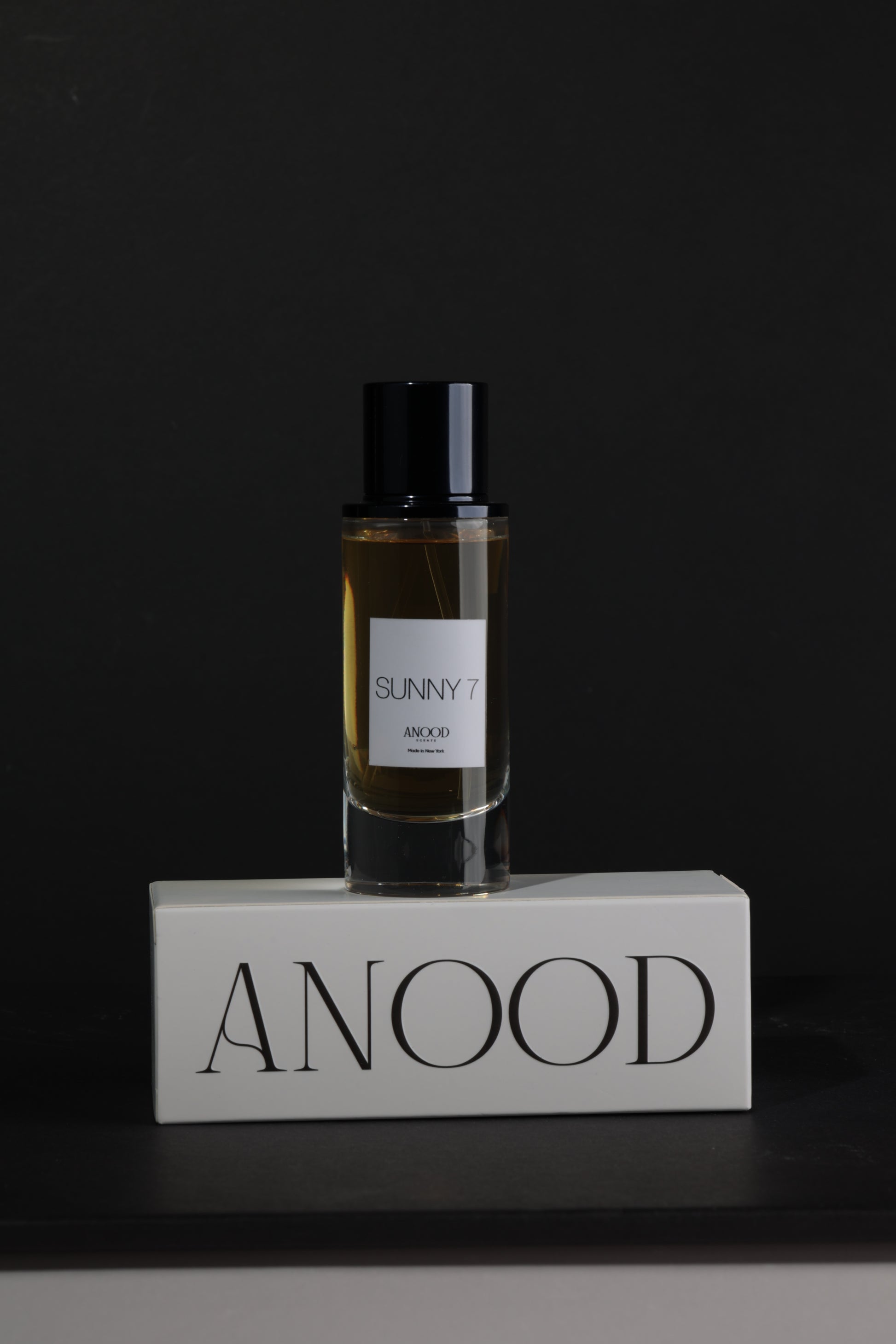 Perfume bottle with a label on a dark background