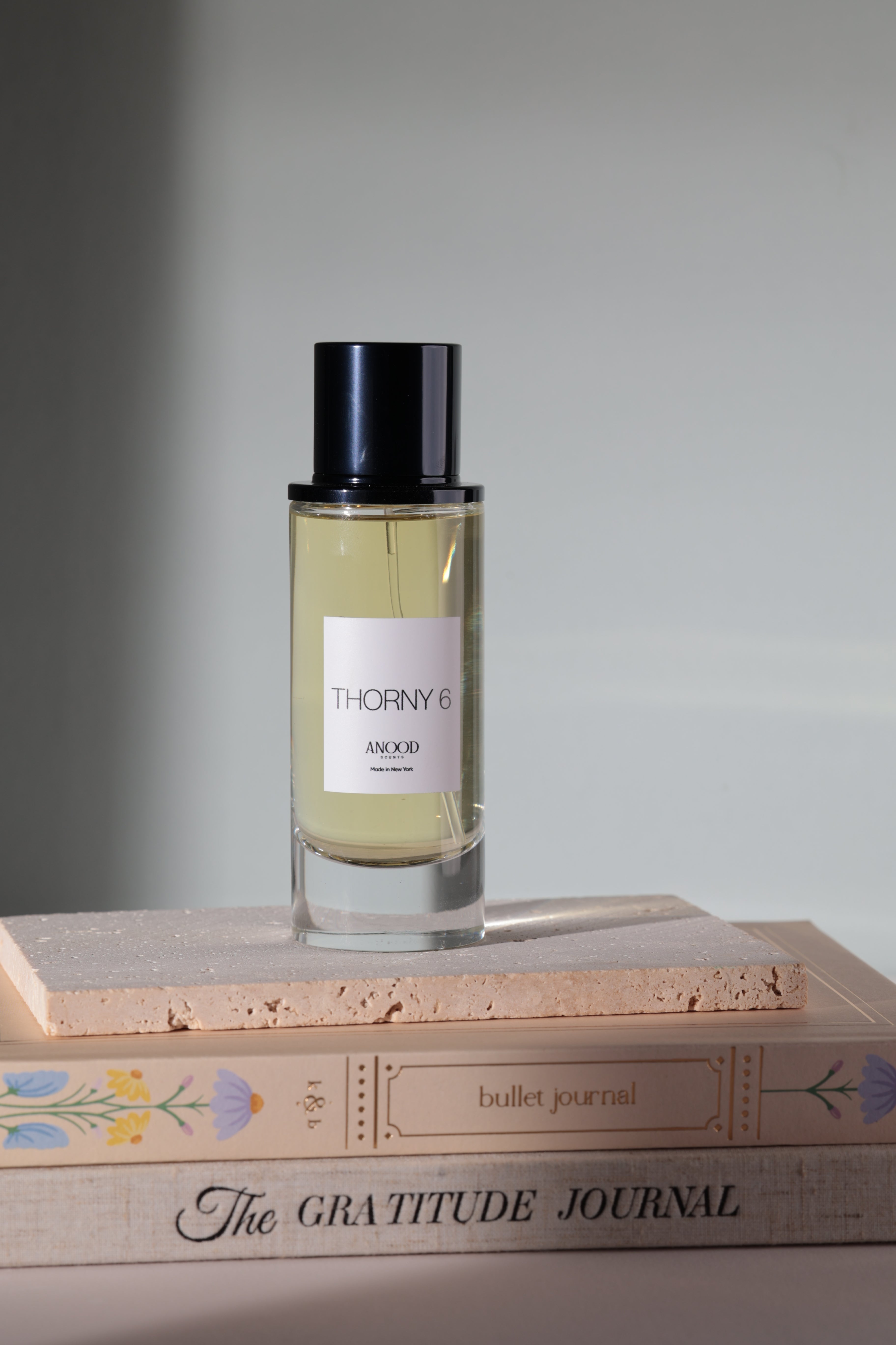 Thierry Mugler perfume bottle on a light gray background