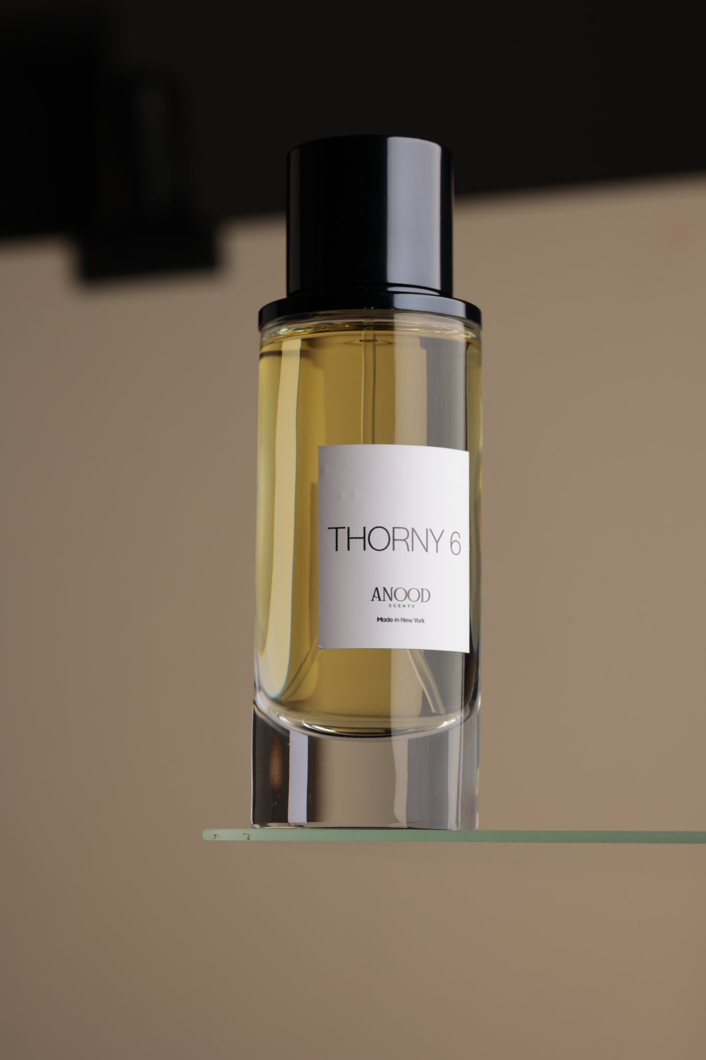 Perfume bottle with a label on a reflective surface